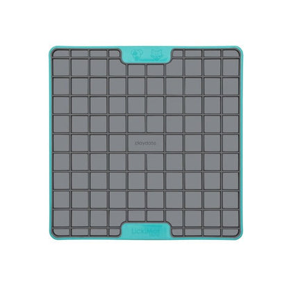 A turquoise square hard case rubber mat with squares inside.
