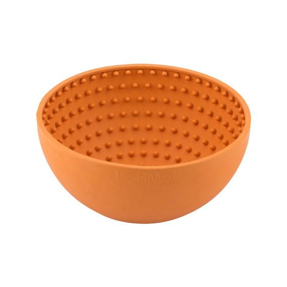 A orange rubber bowl with small nubs inside.